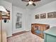 Cozy Bedroom with a wooden crib, plantation shutters, and elegant framed art adding warmth to the room at 12327 Glenfield Ave, Tampa, FL 33626