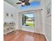 Dining room with hardwood floors, large windows overlooking the backyard, and elegant furniture at 12327 Glenfield Ave, Tampa, FL 33626