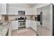 Bright kitchen featuring granite countertops, stainless steel appliances, and white cabinetry at 12327 Glenfield Ave, Tampa, FL 33626