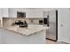 A view of the kitchen featuring stainless steel appliances and light-colored cabinets at 12327 Glenfield Ave, Tampa, FL 33626