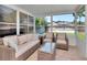 Enclosed lanai with wicker furniture perfect for outdoor relaxation and entertaining at 12327 Glenfield Ave, Tampa, FL 33626
