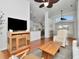 Bright living room with hardwood floors, vaulted ceilings, ceiling fans, and modern furnishings, open to the kitchen at 12327 Glenfield Ave, Tampa, FL 33626
