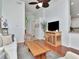 Bright living room featuring hardwood floors, a white sofa, modern decor, and a seamless flow to other rooms at 12327 Glenfield Ave, Tampa, FL 33626