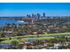 Sweeping aerial view capturing a beautiful neighborhood with lush greenery, waterways, and a stunning city skyline at 1325 Snell Isle Ne Blvd # 911, St Petersburg, FL 33704