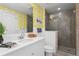 Modern bathroom with glass-enclosed shower, vanity, and 'Sunshine' motif wallpaper at 1325 Snell Isle Ne Blvd # 911, St Petersburg, FL 33704