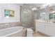 Elegant bathroom with soaking tub, glass-enclosed shower, and vanity with modern fixtures, with marble tile at 1325 Snell Isle Ne Blvd # 911, St Petersburg, FL 33704