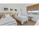 Bright bedroom with twin beds, stylish decor, and a window offering picturesque views at 1325 Snell Isle Ne Blvd # 911, St Petersburg, FL 33704