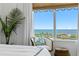 Relaxing bedroom with large windows and a ocean view, complemented by stylish decor and a cozy chair in the corner at 1325 Snell Isle Ne Blvd # 911, St Petersburg, FL 33704