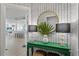 Stylish entryway with patterned wallpaper, round gold mirror, green table, and view into the adjacent living spaces at 1325 Snell Isle Ne Blvd # 911, St Petersburg, FL 33704