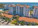 Stunning exterior view of a high-rise building with a red tile roof, manicured landscaping, and elegant entrance at 1325 Snell Isle Ne Blvd # 911, St Petersburg, FL 33704