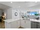 Bright kitchen featuring a bar top, with stainless appliances and an open view to the living area at 1325 Snell Isle Ne Blvd # 911, St Petersburg, FL 33704