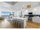 Open-concept kitchen with white cabinets, an island, and stainless steel appliances with ocean view at 1325 Snell Isle Ne Blvd # 911, St Petersburg, FL 33704