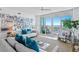 Bright living room with large windows, ocean view, comfortable seating, and stylish decor with lots of pictures at 1325 Snell Isle Ne Blvd # 911, St Petersburg, FL 33704
