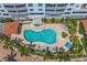 Aerial view of a large community pool with many lounge chairs, cabana, and beautifully landscaped surroundings at 1325 Snell Isle Ne Blvd # 911, St Petersburg, FL 33704