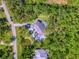 High angle aerial view featuring lush foliage, a serene pond, a pool, and the home's layout and surroundings at 13483 Heritage Way, Sarasota, FL 34240