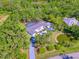 Breathtaking aerial shot displaying a beautiful home with a pool, pond, surrounded by a vibrant green landscape at 13483 Heritage Way, Sarasota, FL 34240