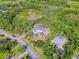 Expansive aerial view of estate nestled among lush greenery, showcasing a large lot, pool, and neighboring properties at 13483 Heritage Way, Sarasota, FL 34240