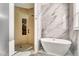 Modern bathroom with soaking tub, large marble shower, and stylish fixtures at 13483 Heritage Way, Sarasota, FL 34240