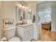 Updated half bathroom featuring granite countertop, decorative mirror and decor at 13483 Heritage Way, Sarasota, FL 34240