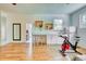 Open bedroom with a wet bar, two bar stools, and an exercise bike at 13483 Heritage Way, Sarasota, FL 34240