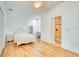 Bright bedroom features wood floors, white walls, and a door leading to a tiled bathroom at 13483 Heritage Way, Sarasota, FL 34240