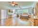 Large room features hardwood floors, large windows, kitchenette, and bedroom setup at 13483 Heritage Way, Sarasota, FL 34240