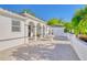 Side view of elegant estate featuring paved driveway with fountain and lush landscaping at 13483 Heritage Way, Sarasota, FL 34240