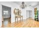 Elegant foyer boasts hardwood floors, classic mirror, and a unique chandelier at 13483 Heritage Way, Sarasota, FL 34240