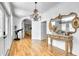 Elegant foyer boasts hardwood floors, classic mirror, and a unique chandelier at 13483 Heritage Way, Sarasota, FL 34240