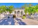 Charming two-story home with lush palm trees, manicured garden beds, and a brick paver driveway at 13483 Heritage Way, Sarasota, FL 34240
