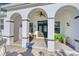 Elegant front porch with decorative columns, arched entryways, and dark wood front door at 13483 Heritage Way, Sarasota, FL 34240
