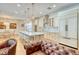 Open-concept kitchen with quartz countertop island, pendant lighting, and stainless steel appliances at 13483 Heritage Way, Sarasota, FL 34240