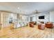 Open-concept kitchen with an island, pendant lighting, stainless appliances, and hardwood floors at 13483 Heritage Way, Sarasota, FL 34240