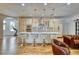 Modern kitchen with a large quartz countertop island, designer lighting, and stylish bar stools at 13483 Heritage Way, Sarasota, FL 34240