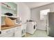 Laundry room boasts wood countertops, sink, and a washer and dryer near a window at 13483 Heritage Way, Sarasota, FL 34240