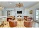 Spacious living room featuring a decorative fireplace, modern decor, and wood floors at 13483 Heritage Way, Sarasota, FL 34240