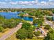 Scenic aerial view of a lakeside community, playground, and lush greenery at 1390 S Hillcrest Ave, Clearwater, FL 33756