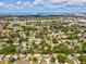 Wide aerial shot of the property nestled among trees, with a view of the cityscape in the distance at 1390 S Hillcrest Ave, Clearwater, FL 33756