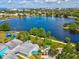 Overhead view of a recreational area featuring a playground and walking paths, surrounded by lush greenery and a calm lake at 1390 S Hillcrest Ave, Clearwater, FL 33756