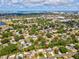 Aerial view of a residential neighborhood with mature trees and glimpses of a city skyline in the background at 1390 S Hillcrest Ave, Clearwater, FL 33756