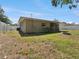 Back of house showing fence, fire pit, and yard at 1390 S Hillcrest Ave, Clearwater, FL 33756