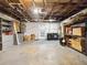 Full view of the unfinished basement with storage shelving and washer and dryer at 1390 S Hillcrest Ave, Clearwater, FL 33756