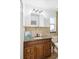 Bathroom with granite vanity, decorative mirror, and updated faucet at 1390 S Hillcrest Ave, Clearwater, FL 33756