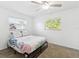 Cozy bedroom with a ceiling fan and two windows offering natural light and outdoor views at 1390 S Hillcrest Ave, Clearwater, FL 33756