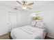 Cozy bedroom with ceiling fan, closet, and a bright window at 1390 S Hillcrest Ave, Clearwater, FL 33756