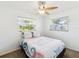 Bright bedroom featuring two windows, a ceiling fan, and ample natural light at 1390 S Hillcrest Ave, Clearwater, FL 33756