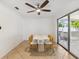 Bright dining area with a ceiling fan, sliding glass doors, and tile flooring at 1390 S Hillcrest Ave, Clearwater, FL 33756