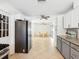 Open kitchen featuring stainless steel appliances, tile floors, and views of the dining area at 1390 S Hillcrest Ave, Clearwater, FL 33756