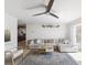 Bright living room with neutral decor, a ceiling fan, and a view into the kitchen at 1390 S Hillcrest Ave, Clearwater, FL 33756