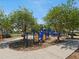 A colorful playground under shady trees has structures for climbing, sliding, and exploring at 1390 S Hillcrest Ave, Clearwater, FL 33756